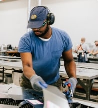 Man with safety equipment working on a manufacturing project